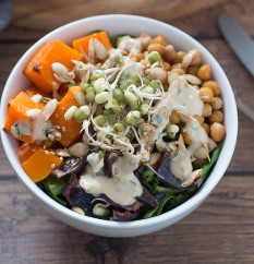 ### Butternut Squash Buddha Bowl Recipe A **Butternut Squash Buddha Bowl** is a delicious, vibrant, and nourishing meal that incorporates a variety of textures and flavors. It’s the perfect combination of roasted butternut squash, fresh veggies, grains, legumes, and a flavorful dressing. This dish is a great option for a nutritious lunch or dinner, and can easily be customized to suit different dietary preferences, including vegan and gluten-free. Here's a detailed recipe to make a hearty **Butternut Squash Buddha Bowl**: --- ### **Ingredients:** #### For the roasted butternut squash: - 1 medium-sized butternut squash, peeled, deseeded, and cut into cubes - 1 tbsp olive oil - 1 tsp ground cinnamon - 1/2 tsp ground nutmeg - 1/4 tsp ground cumin - Salt and pepper to taste #### For the base: - 1 cup cooked quinoa (or rice, farro, or another grain of your choice) - 1 cup cooked chickpeas (or another legume like black beans or lentils) #### Fresh veggies: - 1/2 cup shredded red cabbage - 1 cup spinach or kale, chopped - 1 small avocado, sliced - 1/2 cucumber, thinly sliced - 1/4 cup cherry tomatoes, halved - 1/4 cup grated carrots #### For the dressing (Tahini Lemon Dressing): - 2 tbsp tahini - 1 tbsp lemon juice - 1 tbsp olive oil - 1 tsp maple syrup or honey (optional) - 1-2 tbsp water to thin the dressing - Salt and pepper to taste - 1/2 tsp garlic powder (optional) #### Optional toppings: - Toasted pumpkin seeds, sesame seeds, or sunflower seeds - Fresh cilantro or parsley - Red pepper flakes for heat (optional) --- ### **Instructions:** #### **Step 1: Roast the Butternut Squash** 1. **Preheat the oven** to 400°F (200°C). 2. **Prepare the butternut squash**: Peel, deseed, and chop the butternut squash into bite-sized cubes. 3. **Season the squash**: In a large bowl, toss the cubed squash with olive oil, cinnamon, nutmeg, cumin, salt, and pepper. Make sure each piece is evenly coated with the spices and oil. 4. **Roast**: Spread the squash cubes in a single layer on a baking sheet. Roast for 25-30 minutes, flipping halfway through, until the squash is tender and lightly browned on the edges. 5. **Remove from the oven** and set aside. #### **Step 2: Prepare the Grain Base** 1. **Cook your grain** (quinoa, rice, farro, or any choice of grain). If you're using quinoa, cook it according to the package instructions (usually 1 part quinoa to 2 parts water, bring to a boil, then simmer for about 15 minutes until water is absorbed). 2. **Cook the chickpeas** (if using canned, drain and rinse them). If you're using dried chickpeas, cook them until tender (this can take 1-1.5 hours). You can also roast them for extra crunch and flavor with olive oil, salt, and spices. #### **Step 3: Prepare Fresh Vegetables** 1. **Chop the fresh veggies**: Shred the red cabbage, chop the spinach or kale, slice the cucumber, and halve the cherry tomatoes. 2. **Slice the avocado** into thin slices and set aside. #### **Step 4: Make the Tahini Lemon Dressing** 1. **Combine tahini, lemon juice, olive oil, and maple syrup (if using)** in a small bowl or jar. 2. **Whisk together** or shake in a jar until smooth. If the dressing is too thick, add 1-2 tablespoons of water until it reaches your desired consistency. 3. **Season with garlic powder**, salt, and pepper, and adjust flavors as needed. #### **Step 5: Assemble the Buddha Bowl** 1. **Start with the grain base**: Spoon your cooked quinoa (or other grains) into bowls as the base of your Buddha bowl. 2. **Add roasted butternut squash**: Place a portion of the roasted butternut squash on top of the grains. 3. **Add chickpeas**: Spoon a generous portion of cooked or roasted chickpeas on top. 4. **Pile on fresh veggies**: Add your shredded cabbage, spinach or kale, cucumber, tomatoes, and grated carrots. 5. **Top with avocado** slices for creaminess. 6. **Drizzle with the tahini lemon dressing**: Pour the dressing generously over the bowl. 7. **Optional toppings**: Sprinkle some toasted seeds or herbs (cilantro or parsley) over the top for added crunch and flavor. You can also add a pinch of red pepper flakes if you prefer a bit of heat. --- ### **Tips for Customization:** - **Add nuts or seeds**: To add a crunchy texture, you can include nuts like almonds, walnuts, or pumpkin seeds. - **Add other roasted veggies**: Feel free to add roasted sweet potatoes, Brussels sprouts, or cauliflower for more variety. - **Switch up the dressing**: If you're not a fan of tahini, you can try a lemon-tahini dressing, or use a simple balsamic vinaigrette or a creamy avocado dressing. - **Make it spicy**: Add chili flakes, sriracha, or hot sauce to give it a spicy kick. - **Make it protein-packed**: Add a boiled egg or grilled chicken to increase the protein content. --- ### **Why This Bowl Is So Great:** 1. **Nutrient-rich**: Packed with vitamins and minerals from the squash, greens, and fresh veggies. 2. **Satisfying and hearty**: The roasted butternut squash and chickpeas provide fiber and plant-based protein, while the avocado adds healthy fats. 3. **Customizable**: You can easily swap ingredients based on what’s in season or available in your pantry. 4. **Balanced meal**: A perfect blend of carbohydrates, proteins, healthy fats, and a wide variety of antioxidants and nutrients. --- ### **Storage and Meal Prep:** - **Storage**: You can store the components of the Buddha bowl (grains, roasted squash, chickpeas, and dressing) separately in airtight containers in the refrigerator for up to 4 days. Keep the fresh veggies and avocado separate until you’re ready to eat. - **Meal Prep**: You can prepare the grains, roasted squash, and chickpeas ahead of time for easy lunches throughout the week. --- ### **Conclusion:** butternut squash buddha bowl